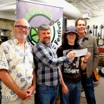 Homegrown Live Productions board members Tom Stewart, Chris Morris and Joel Yearsley present a cheque for $2200 to Joe's MILL librarian Jackson Baird.